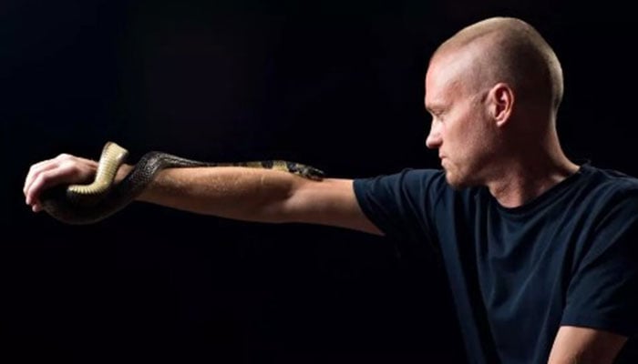 Tim Friede pictured with a snake on his hand. — AFP/File