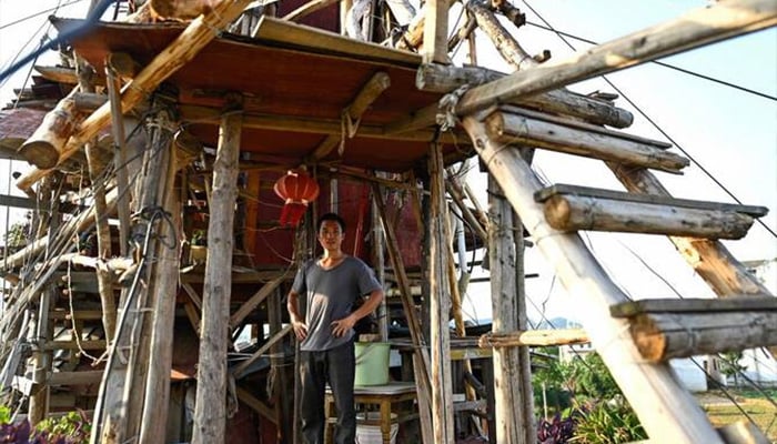Chen Tianmings 10-storey tower of faded plyboards and contorted beams in Chinas Guizhou province. — AFP