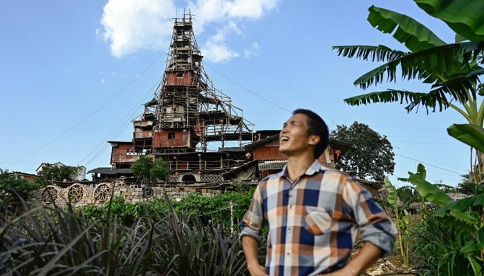 Chen Tianmings 10-storey tower of faded plyboards and contorted beams in Chinas Guizhou province. — AFP