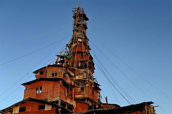 Chen Tianmings 10-storey tower of faded plyboards and contorted beams in Chinas Guizhou province. — AFP