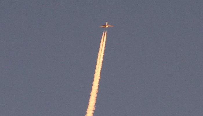 A military aircraft flies in the sky following a barrage of missiles launched from Iran, as seen over Tubas, in the Israeli-occupied West Bank, June 14, 2025. — Reuters
